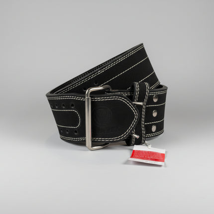 Black leather belt with silver buckle on a beige surface, accompanied by a red tag.